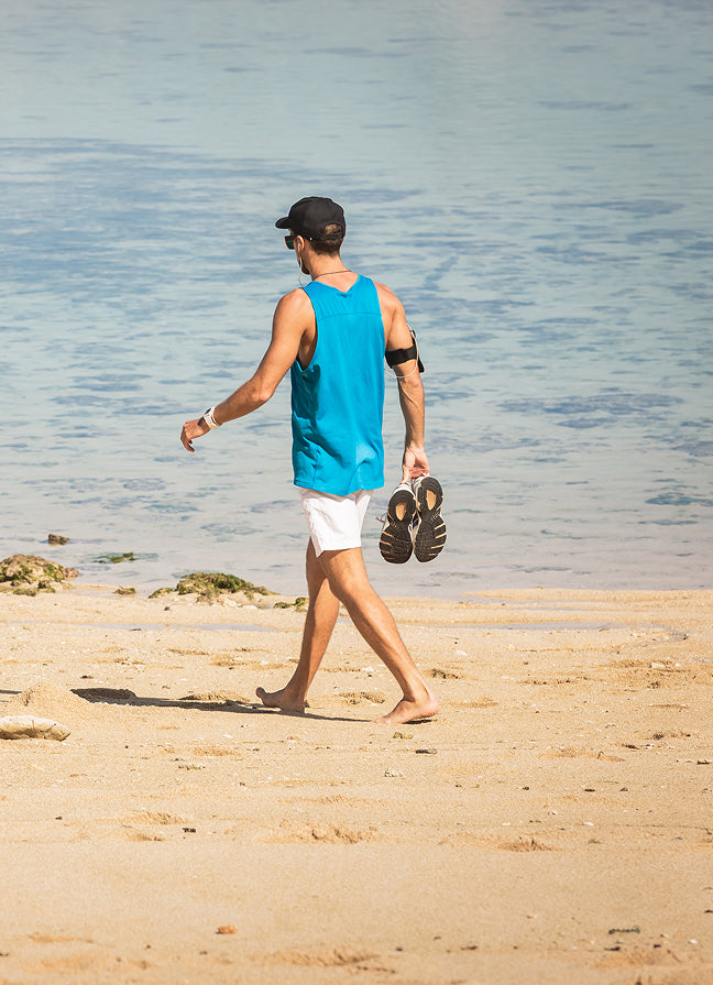 files/barefoot-man-holding-sneakers-and-walking-on-beach-2024-11-14-14-22-17-utc_1.jpg